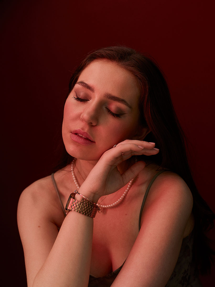 Portrait of actor, Bibi Lucille, with her eyes closed and the back of her left hand touching her right cheek.