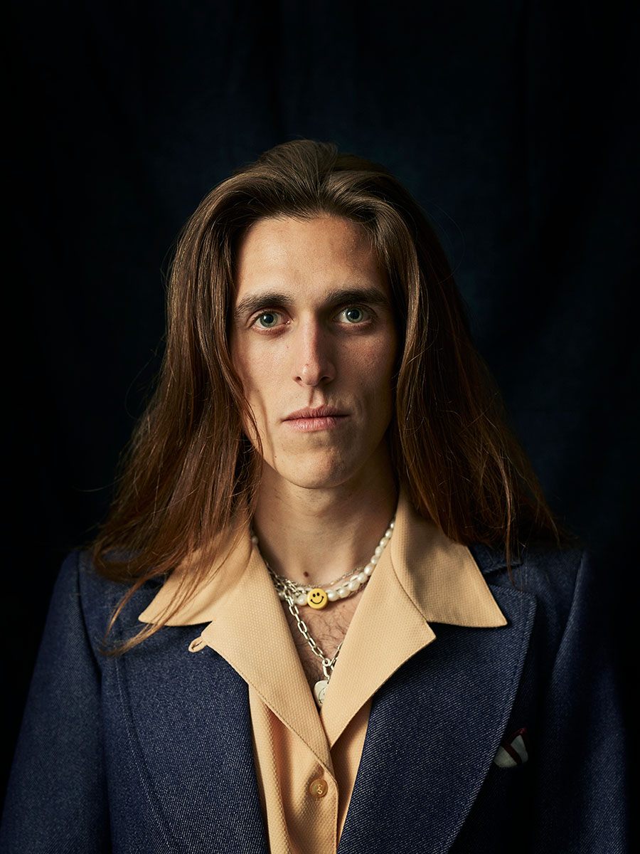 Studio portrait of musician, Harry Morris, wearing a denim suit jacket.